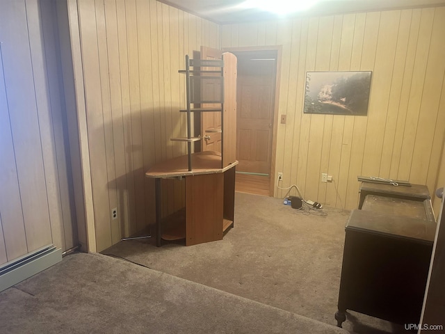 home office featuring wood walls and carpet