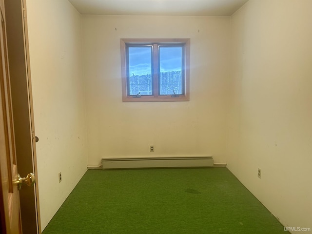 empty room featuring a baseboard radiator and carpet flooring