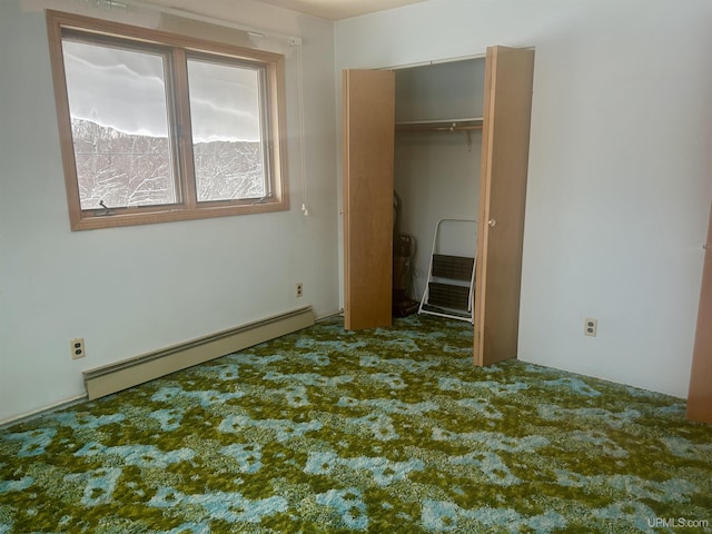 unfurnished bedroom with baseboard heating, a closet, and carpet