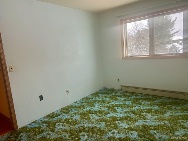 carpeted spare room with a baseboard radiator