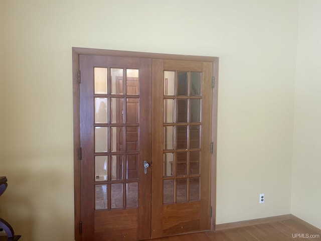 details with french doors and wood-type flooring