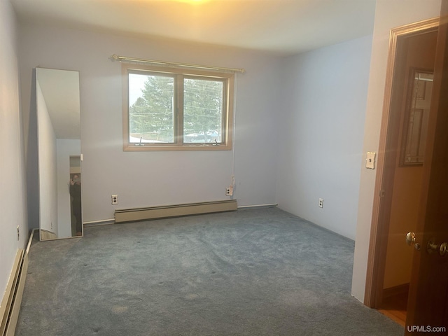 spare room featuring baseboard heating and dark carpet