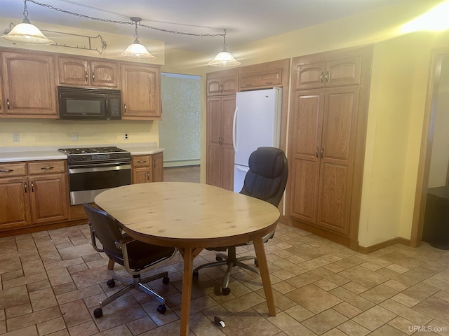 kitchen featuring hanging light fixtures, white fridge, a baseboard radiator, and stainless steel gas range oven