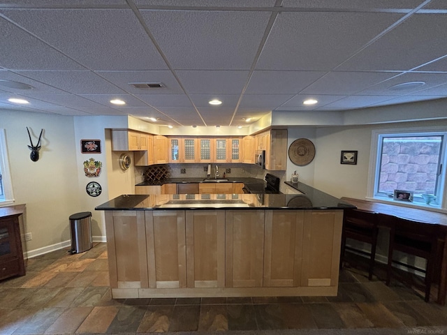 kitchen with sink, a drop ceiling, electric stove, decorative backsplash, and light brown cabinetry