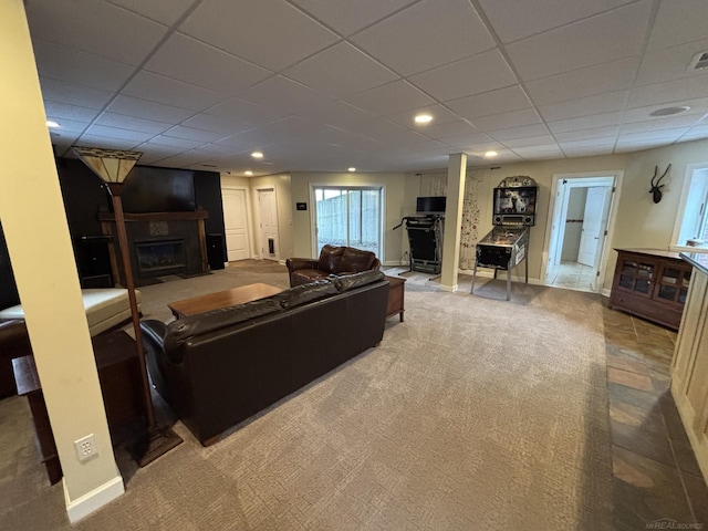 carpeted living room featuring a large fireplace