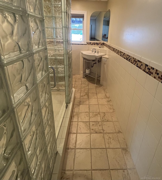 bathroom featuring tile walls and walk in shower