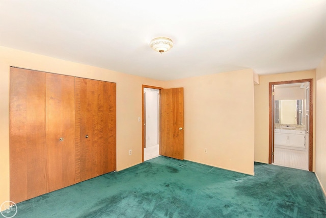 unfurnished bedroom featuring connected bathroom, a closet, and dark carpet