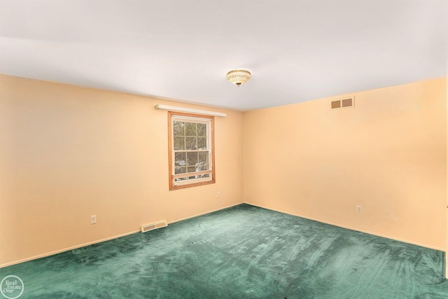 unfurnished room featuring dark colored carpet