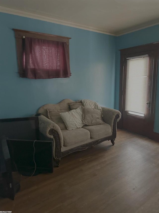 living room with hardwood / wood-style flooring and crown molding