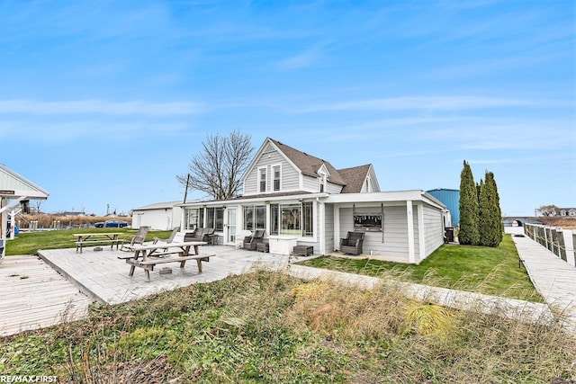 back of property with a lawn and a patio area