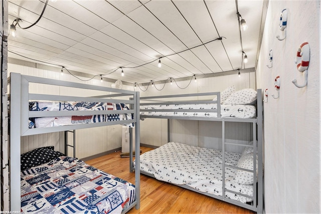 bedroom featuring hardwood / wood-style floors and wooden ceiling