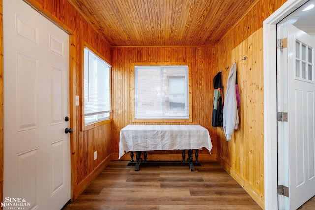 interior space with hardwood / wood-style flooring, wooden ceiling, and wood walls