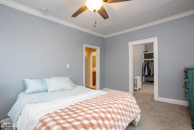 bedroom with radiator, ceiling fan, light colored carpet, a walk in closet, and a closet