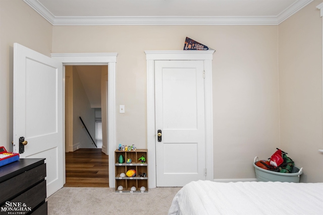 bedroom featuring light carpet and crown molding