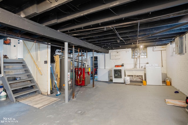 basement with washer and dryer, sink, fridge, and water heater