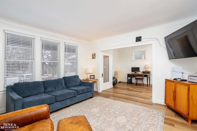 living room featuring light wood-type flooring and radiator heating unit