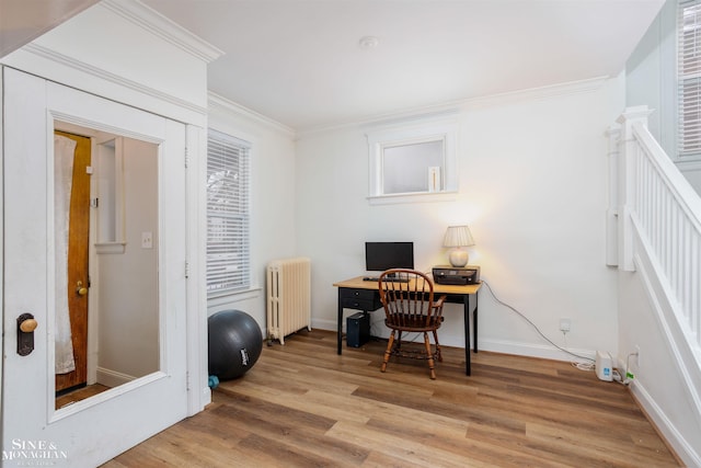 home office with radiator heating unit, light hardwood / wood-style floors, and ornamental molding