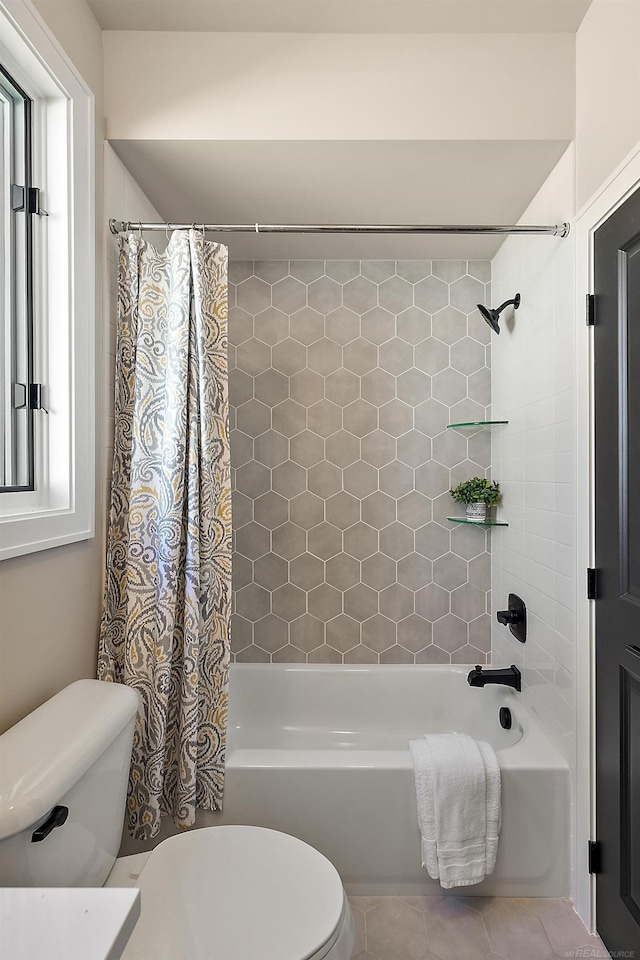 bathroom featuring tile patterned flooring, shower / bathtub combination with curtain, and toilet