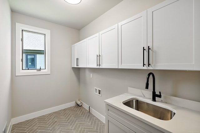 laundry area featuring cabinets, washer hookup, and sink