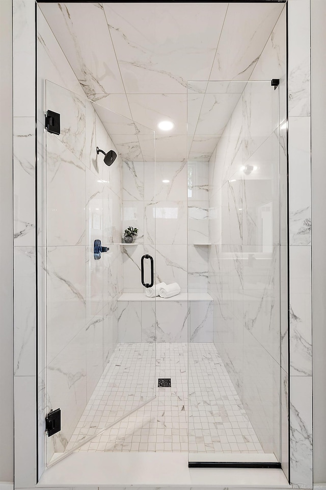 bathroom with a shower with shower door