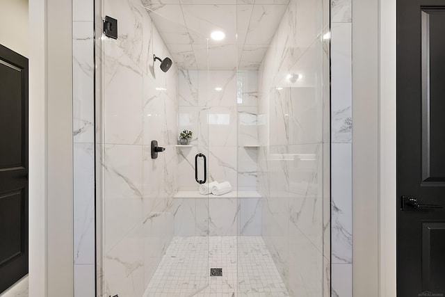 bathroom featuring a shower with door