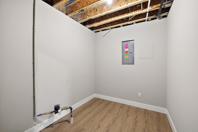 basement featuring wood-type flooring and electric panel