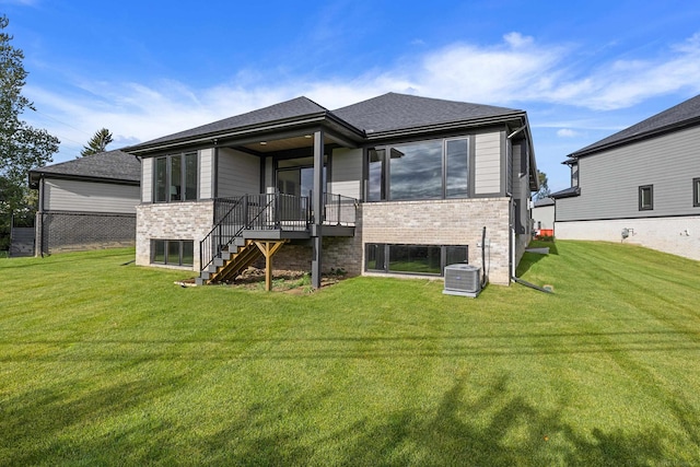 rear view of property featuring a yard