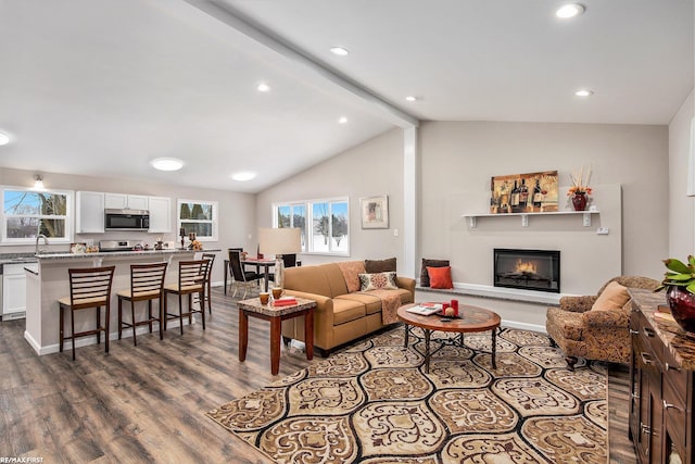 living room featuring hardwood / wood-style flooring and vaulted ceiling with beams