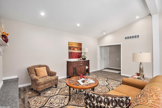 living room with hardwood / wood-style flooring and high vaulted ceiling