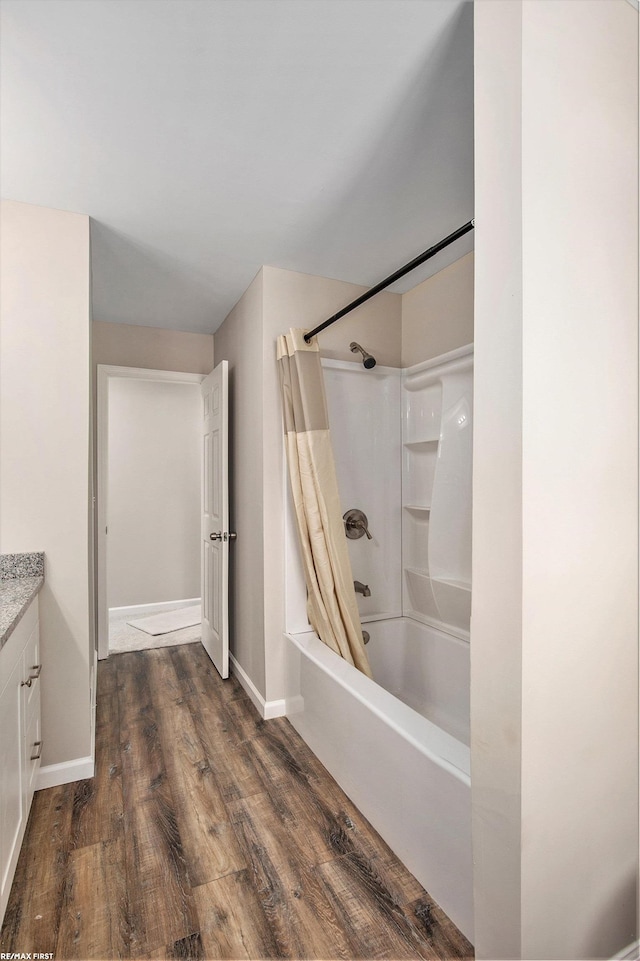 bathroom featuring hardwood / wood-style floors, shower / bath combo, and vanity