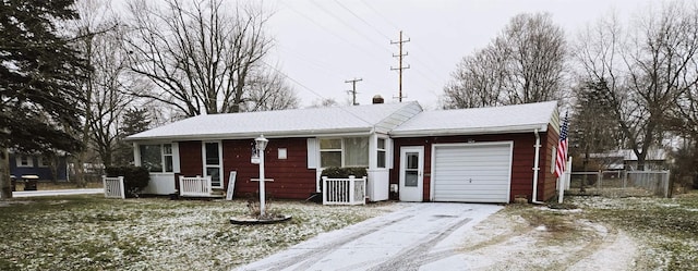 single story home featuring central AC unit and a garage