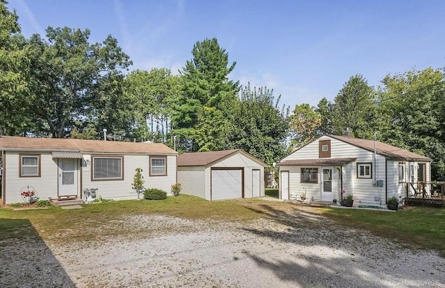 view of front of house with a garage and an outdoor structure