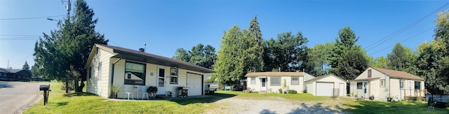 view of front facade with an outbuilding and a front lawn