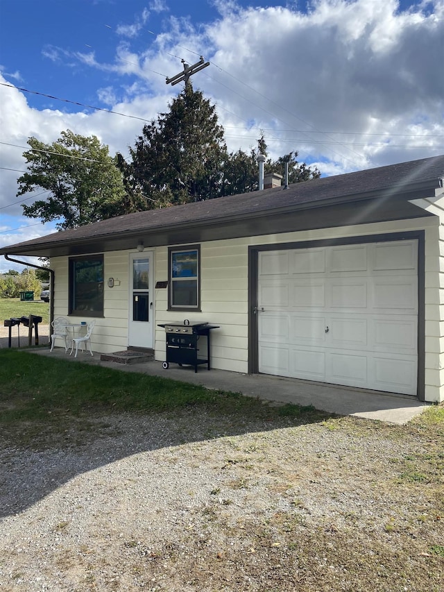 ranch-style home featuring covered porch and a garage