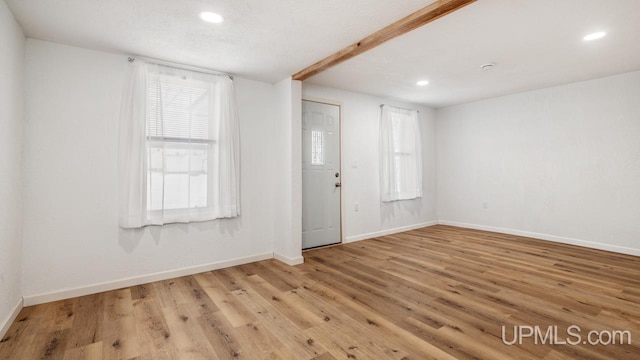 spare room featuring light hardwood / wood-style floors