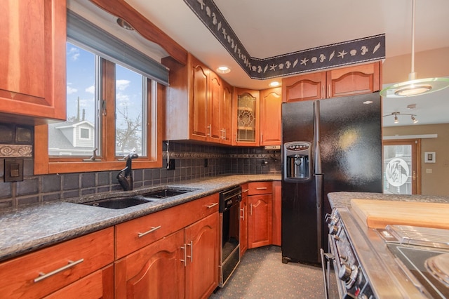 kitchen with decorative light fixtures, black appliances, backsplash, and sink