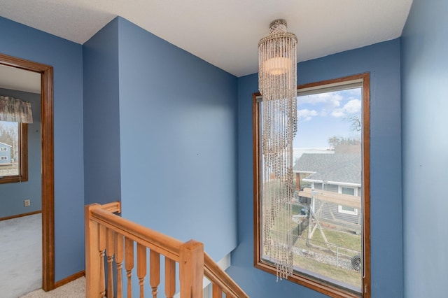 interior space with a notable chandelier and carpet flooring