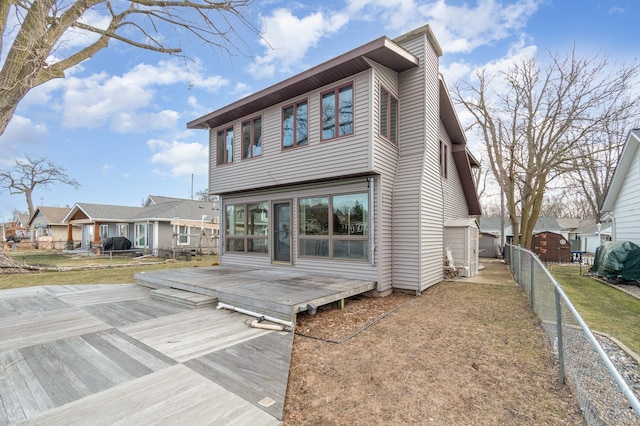 back of house featuring a yard and a wooden deck