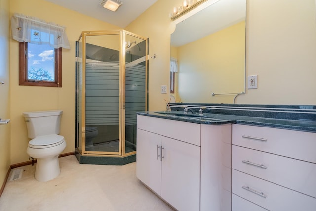 bathroom featuring toilet, walk in shower, and vanity