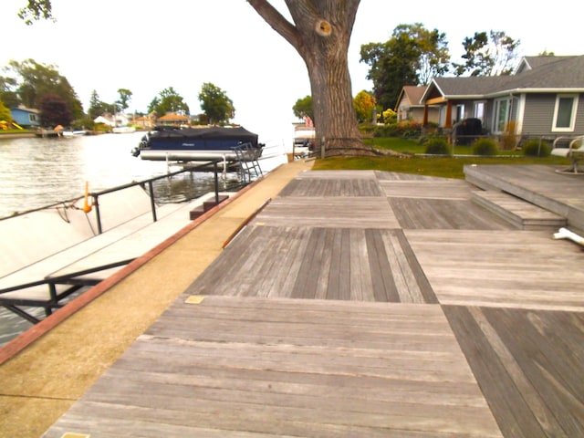 view of home's community with a boat dock and a water view