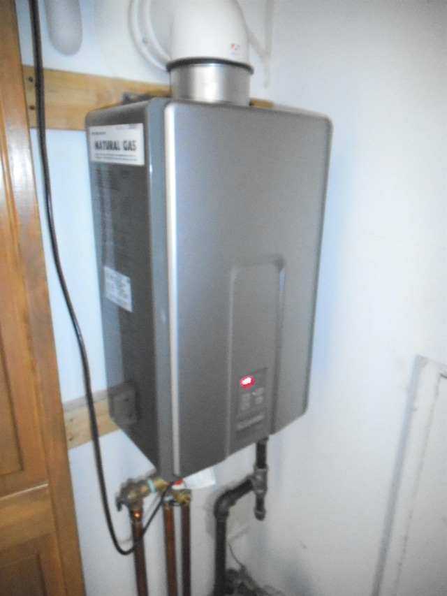 utility room featuring water heater