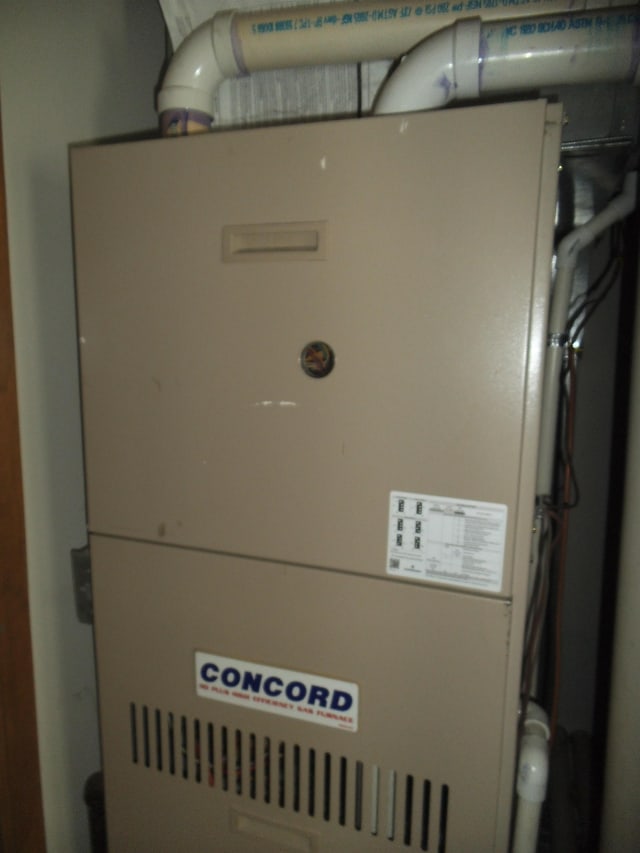 utility room with heating unit