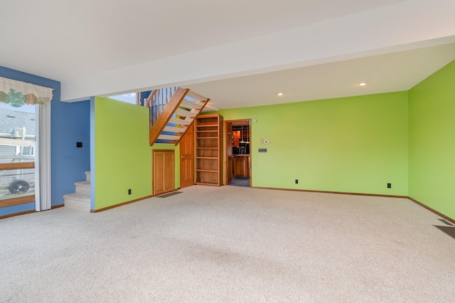 unfurnished living room featuring carpet floors