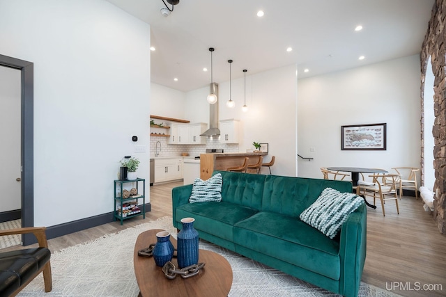 living room with sink and light hardwood / wood-style floors