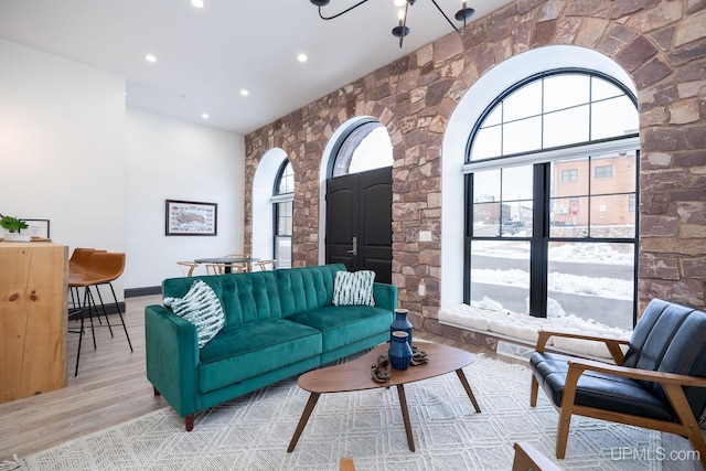 living room with a chandelier and light hardwood / wood-style flooring