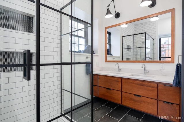 bathroom featuring tile patterned flooring, vanity, and tiled shower