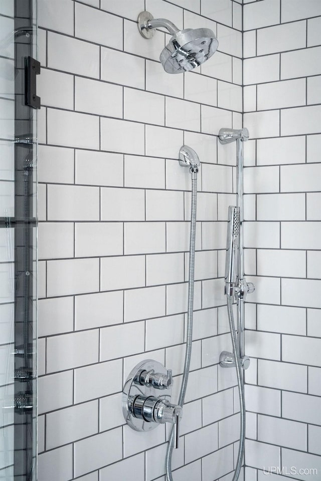 bathroom with tiled shower