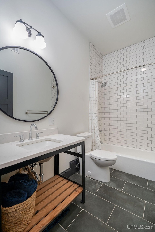 full bathroom with shower / bath combo with shower curtain, toilet, sink, and tile patterned flooring