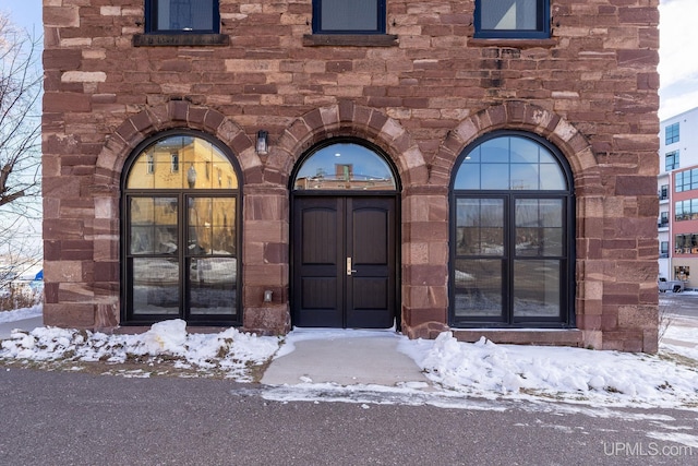 view of snow covered property entrance