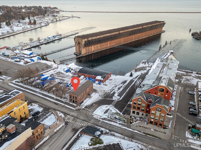 snowy aerial view with a water view